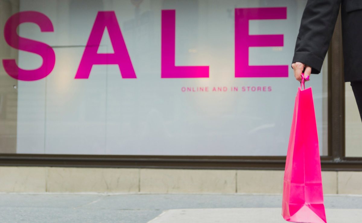 woman-with-shopping-bags-near-sale-lettering_23-2147932257